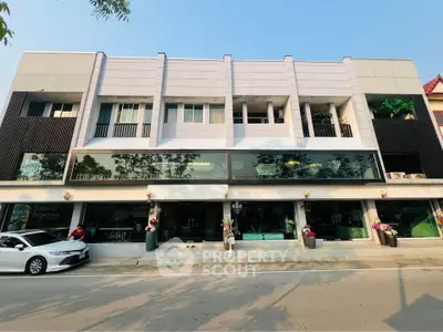 Modern commercial building with large glass windows and street view