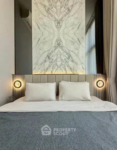 Luxurious bedroom with elegant marble accent wall and ambient lighting
