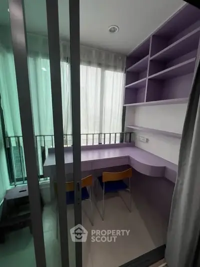 Modern study room with built-in shelves and desk, featuring floor-to-ceiling windows.