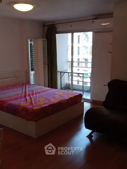 Cozy bedroom with balcony access in modern apartment