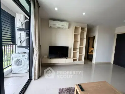 Modern living room with air conditioning and balcony view in a stylish apartment.