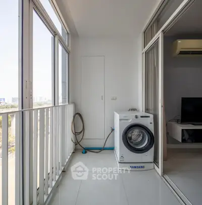 Modern balcony with washing machine and city view, perfect for urban living convenience.