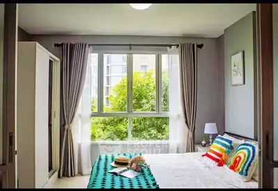 Bright and cozy bedroom with large window and modern decor