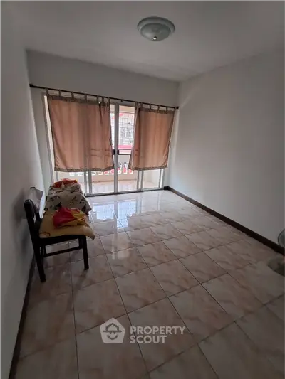 Spacious room with large windows and tiled flooring, perfect for customization.