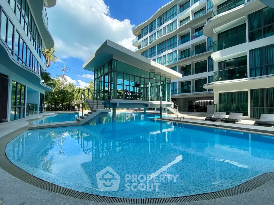 Luxurious modern apartment complex with stunning pool and sleek architecture.