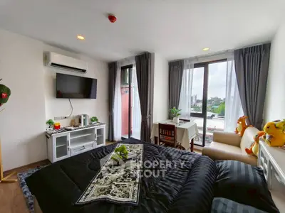 Modern bedroom with large windows and stylish decor in a cozy apartment.