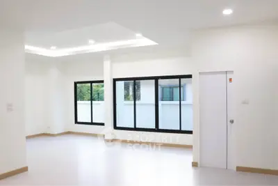 Spacious modern living room with large windows and recessed lighting