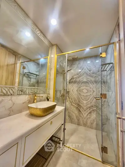 Luxurious bathroom with elegant marble design and gold accents