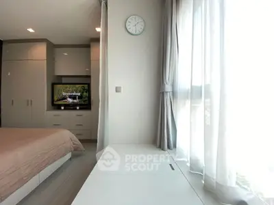 Bright and modern bedroom with large window and stylish decor