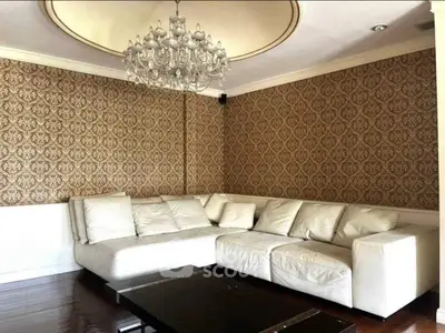 Luxurious living room with elegant chandelier and stylish wallpaper