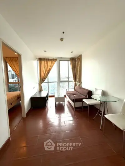 Modern living room with hardwood floors and city view balcony