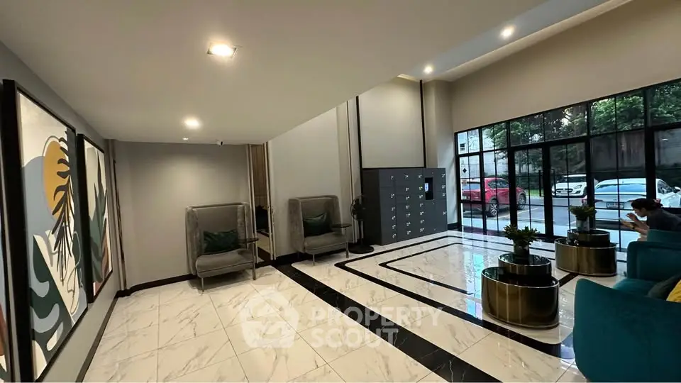 Modern apartment lobby with stylish seating and large windows