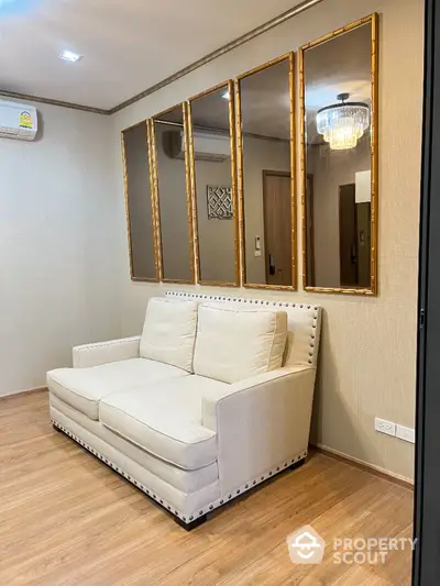 Elegant living room with plush sofa and mirrored wall accents