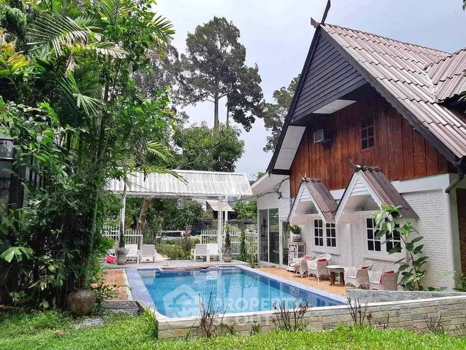 Charming rustic house with inviting pool and lush garden, perfect for serene living.