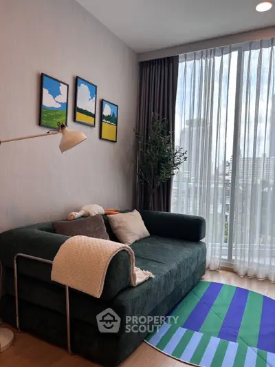 Modern living room with stylish sofa, floor lamp, and large window offering city view.
