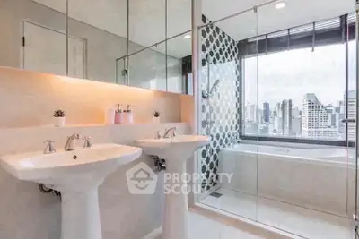 Luxurious bathroom with dual sinks and city view from bathtub in modern apartment.