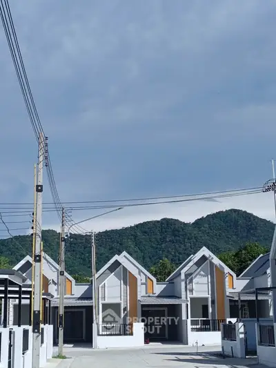 Modern townhouses with mountain backdrop in serene neighborhood