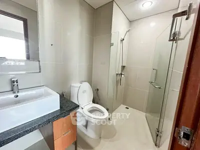 Modern bathroom with sleek fixtures and glass shower enclosure