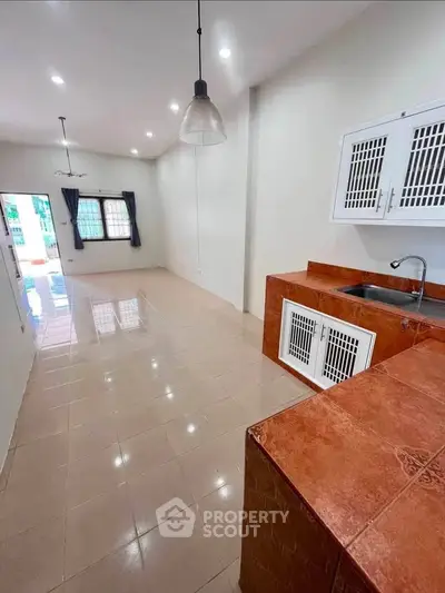 Spacious open-layout kitchen with modern fixtures and ample natural light.