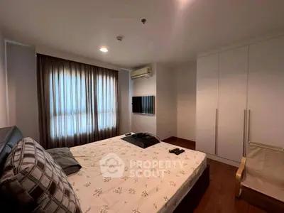 Cozy bedroom with modern decor and ample natural light