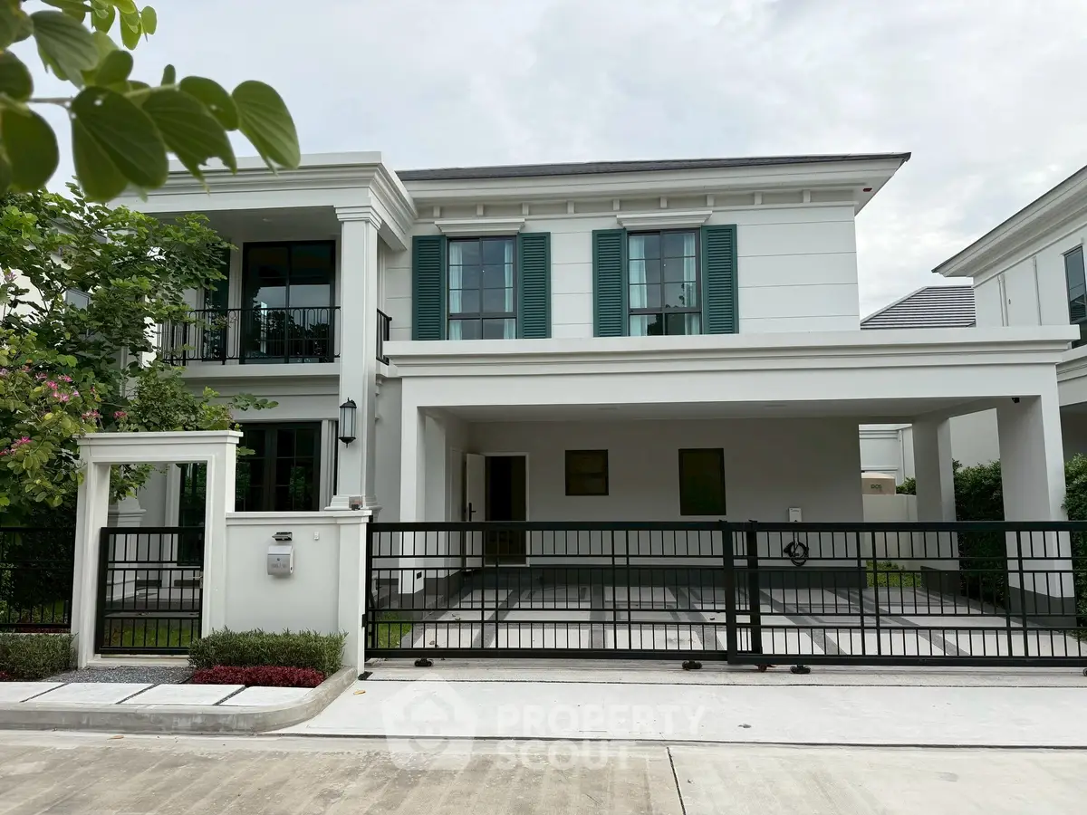 Elegant modern house with green shutters and spacious driveway in a serene neighborhood.