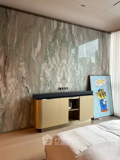 Luxurious bedroom with elegant marble accent wall and stylish furniture