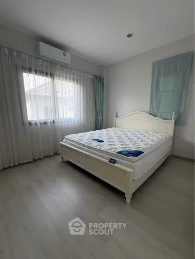 Spacious bedroom with natural light and elegant decor in modern home