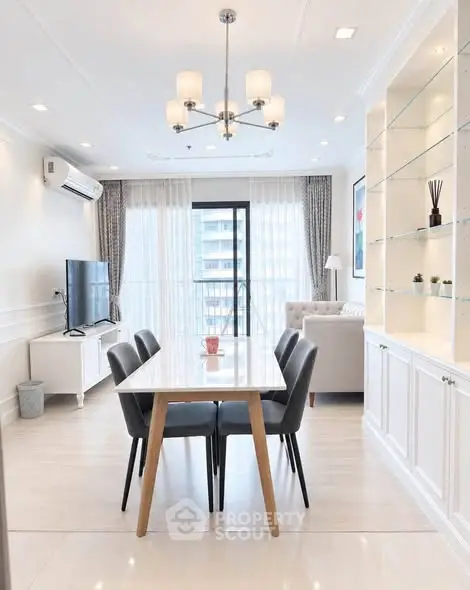 Modern living room with elegant dining area and large windows in a stylish apartment.