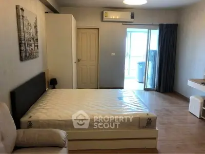 Spacious bedroom with modern decor and balcony access