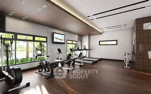 Spacious modern gym with state-of-the-art equipment and large windows.