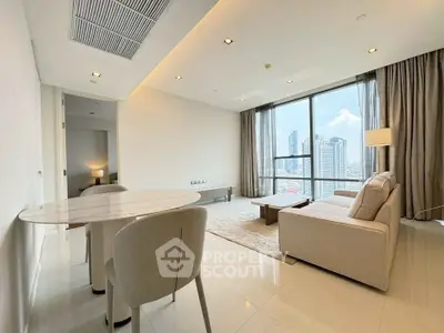 Spacious modern living room with city view, elegant furniture, and natural light.