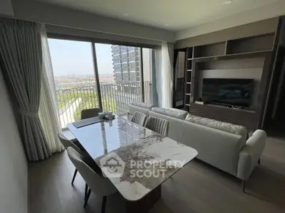 Modern living room with large windows and stunning view, featuring elegant furniture and sleek design.