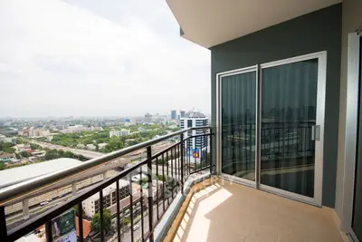 Stunning high-rise balcony with panoramic city views, perfect for urban living.