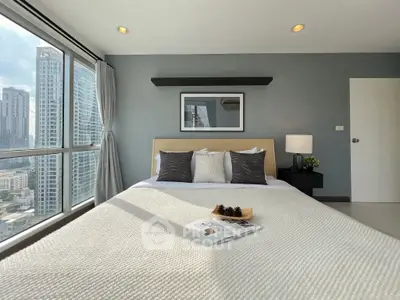 Modern bedroom with city view, large windows, and stylish decor in a high-rise apartment.