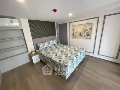 Modern bedroom with stylish decor and built-in storage in a contemporary apartment.