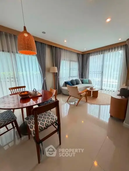 Spacious living room with modern decor and large windows offering natural light.
