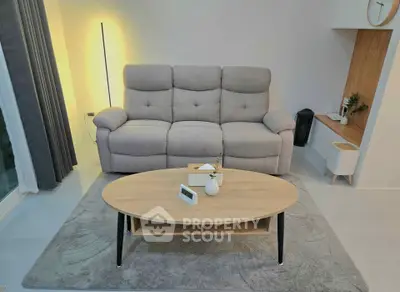 Modern living room with cozy gray sofa and stylish coffee table