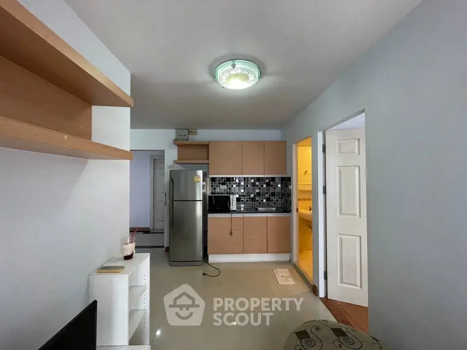 Modern apartment interior with sleek kitchen and cozy living area, perfect for urban living.