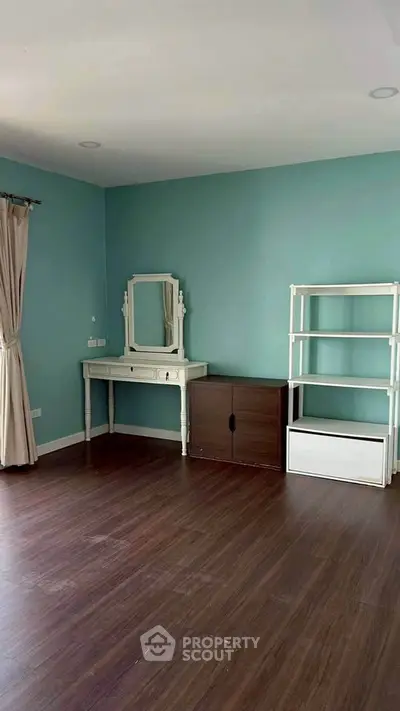 Spacious empty room with elegant vanity and shelving, ideal for customization.