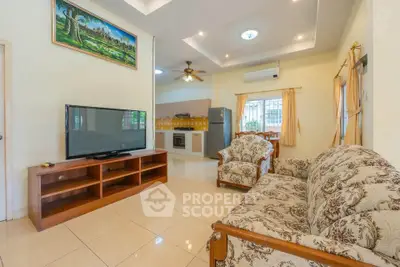 Spacious living room with elegant furniture and modern kitchen in open layout