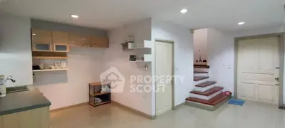 Spacious interior with modern kitchen and staircase, ideal for family living.