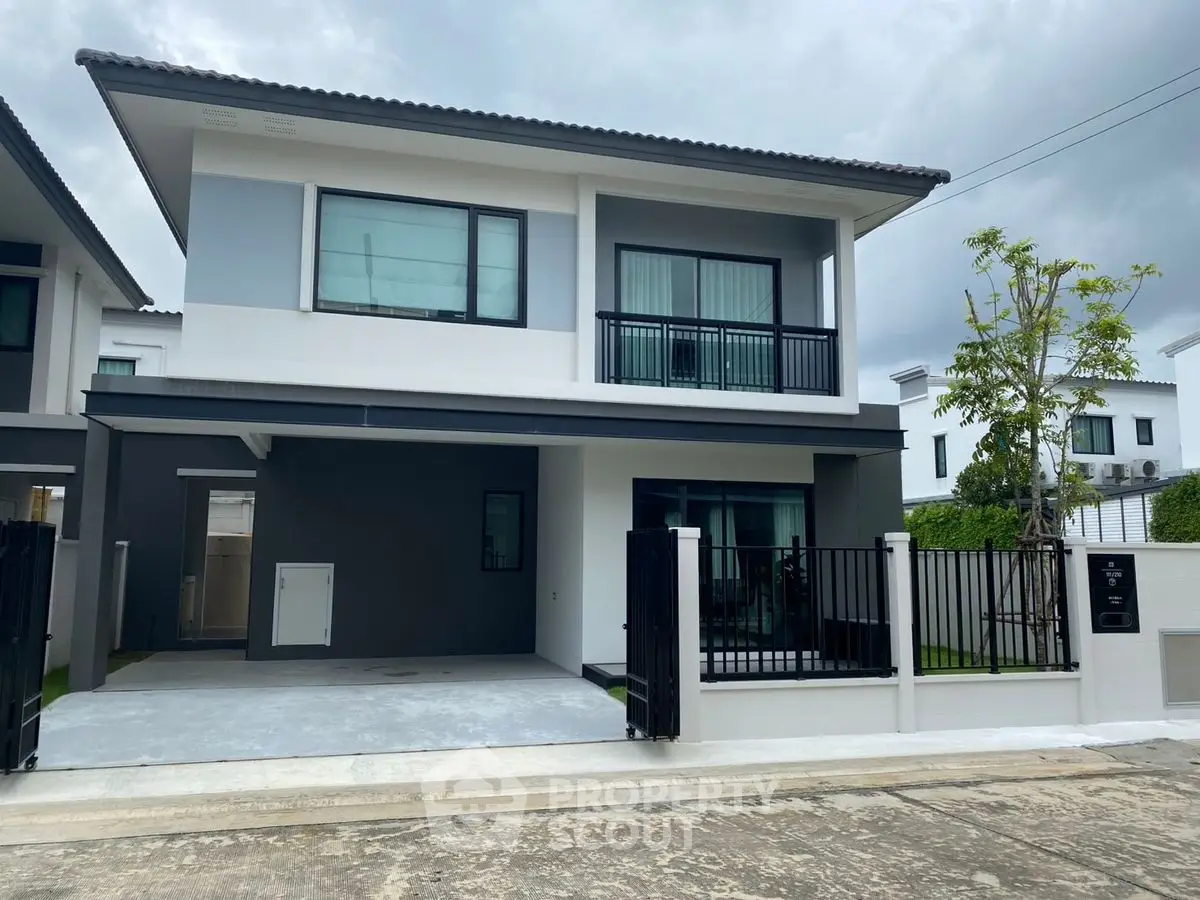 Modern two-story house with sleek design and spacious driveway