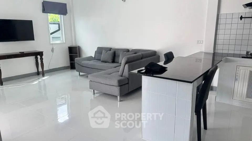 Spacious modern living room with sleek kitchen and stylish furniture