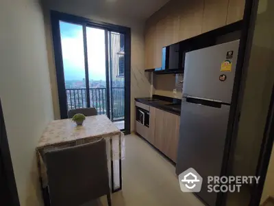 Modern kitchen with balcony view in high-rise apartment