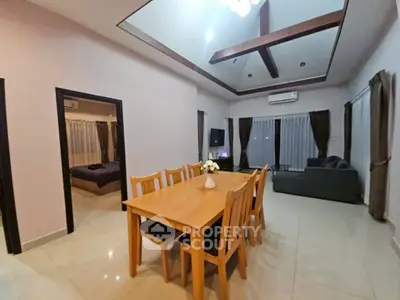 Spacious living and dining area with high ceiling and modern decor