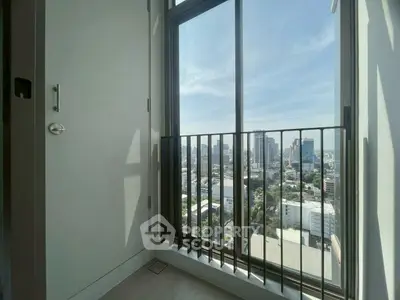 Stunning city view from a modern apartment balcony with sleek railing.