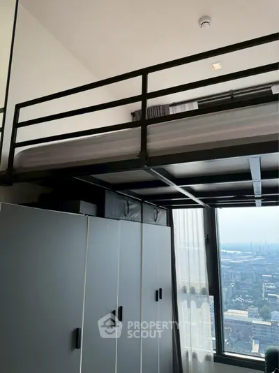 Modern loft bedroom with city view and sleek storage solutions.