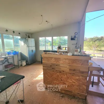 Spacious kitchen with open layout and large windows offering scenic views.