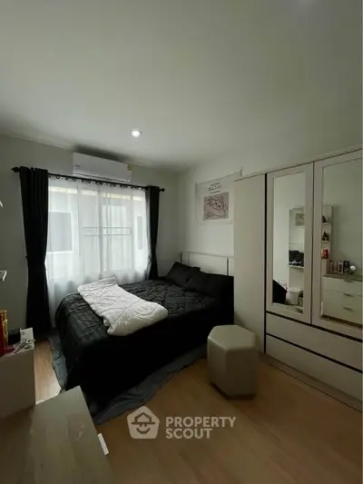 Cozy bedroom with modern decor and ample natural light