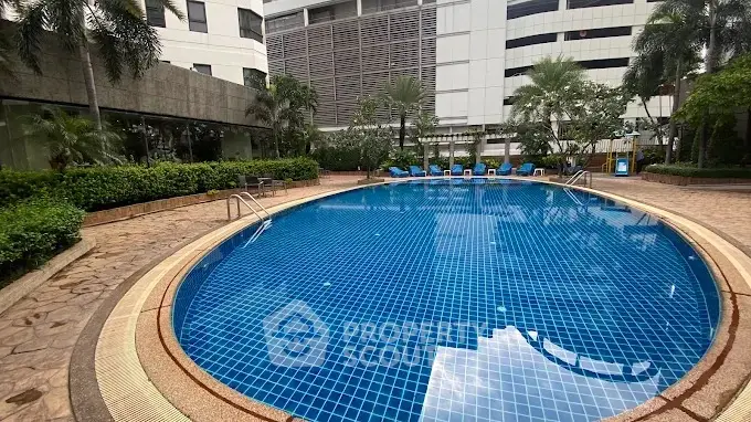 Luxurious residential pool area with modern design and lush greenery